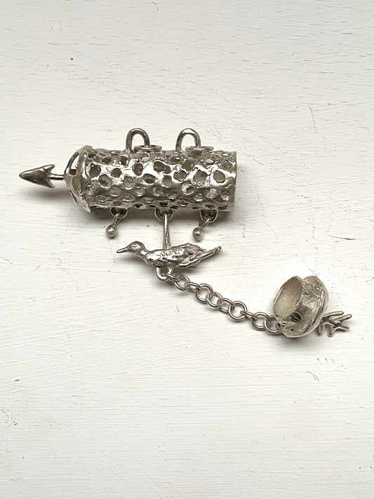 silver aroma barrel locket with bird in flight