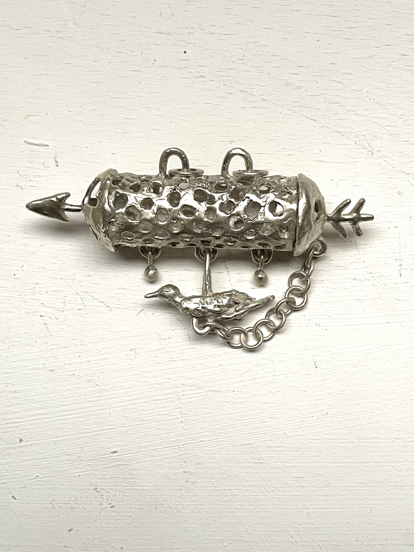 silver aroma barrel locket with bird in flight