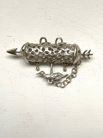 silver aroma barrel locket with bird in flight