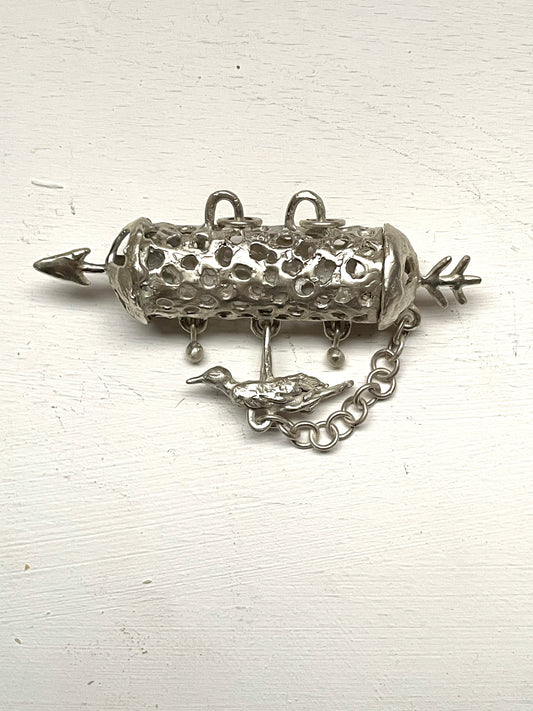 silver aroma barrel locket with bird in flight